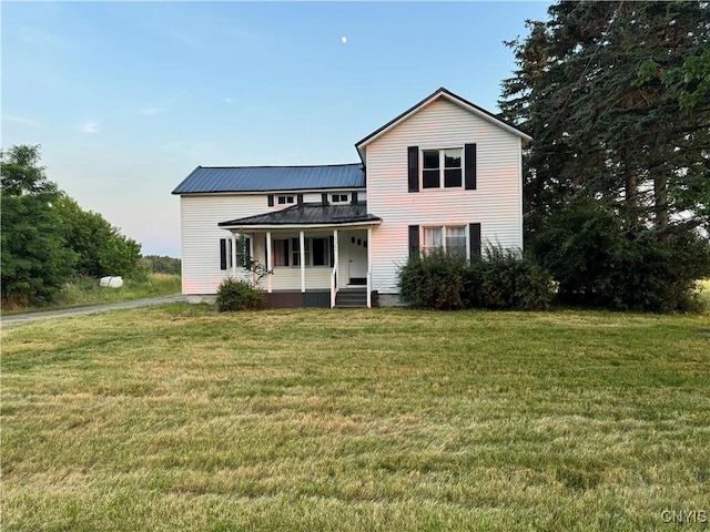 3564 Swartout Rd, Owasco, NY 13021 - traditional-style house featuring covered porch, a front lawn, and a metal roof