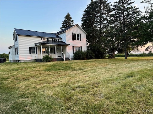 3564 Swartout Rd, Owasco, NY 13021 - view of front facade with a metal roof, a front lawn, and covered porch
