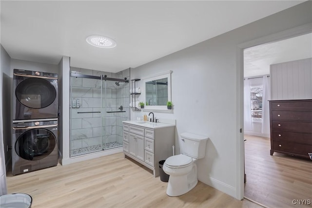 3564 Swartout Rd, Owasco, NY 13021 - bathroom with estacked washer and dryer, wood finished floors, a shower stall, and vanity