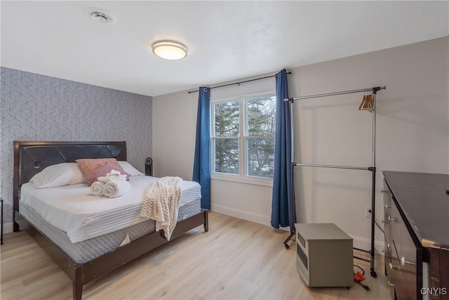 3564 Swartout Rd, Owasco, NY 13021 - bedroom with an accent wall, light wood-style flooring, and wallpapered walls
