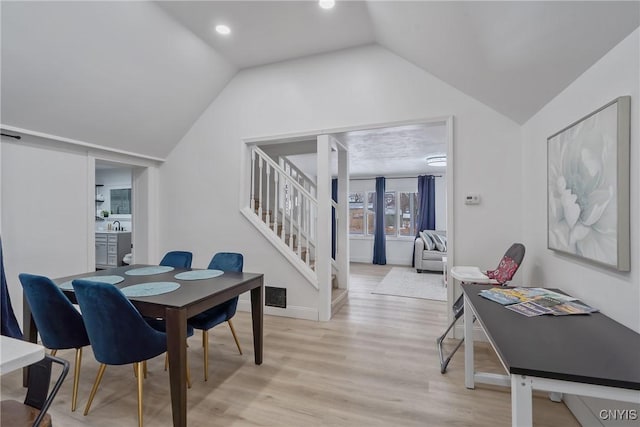 3564 Swartout Rd, Owasco, NY 13021 - dining area with lofted ceiling, light wood-style floors, and stairway