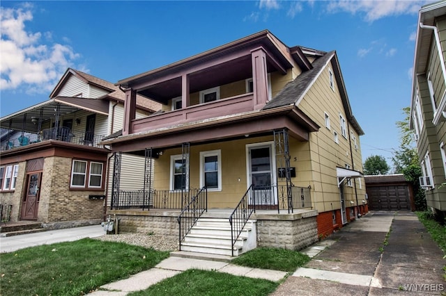 245 Tacoma Ave, Buffalo, NY 14216 - view of front facade with an outdoor structure, a balcony, covered porch, roof with shingles, and a detached garage