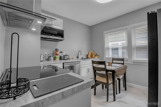 245 Tacoma Ave, Buffalo, NY 14216 - kitchen featuring appliances with stainless steel finishes, light marble finish flooring, white cabinetry, and light countertops