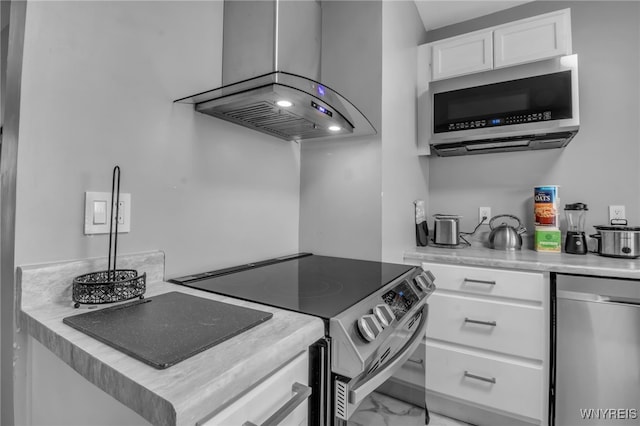 245 Tacoma Ave, Buffalo, NY 14216 - kitchen featuring appliances with stainless steel finishes, white cabinets, light marble finish flooring, light countertops, and island exhaust hood
