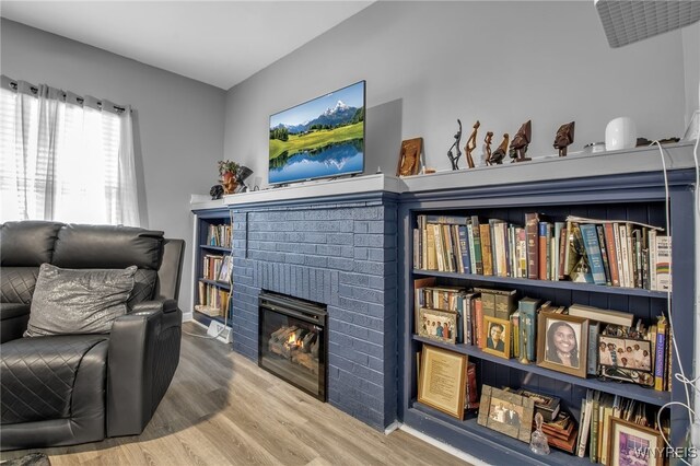 245 Tacoma Ave, Buffalo, NY 14216 - sitting room featuring wood finished floors and a brick fireplace
