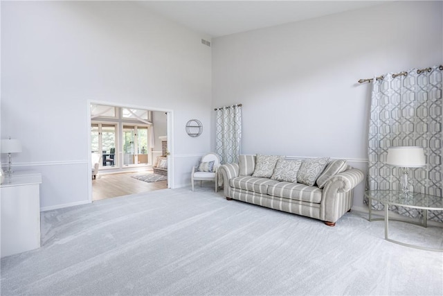 47 Edenfield Rd, Penfield, NY 14526 - living room featuring carpet floors and a towering ceiling