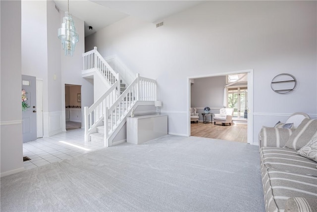 47 Edenfield Rd, Penfield, NY 14526 - carpeted living area with a towering ceiling, stairs, and tile patterned floors