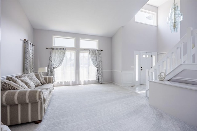 47 Edenfield Rd, Penfield, NY 14526 - living area with plenty of natural light, carpet, stairs, a high ceiling, and a chandelier
