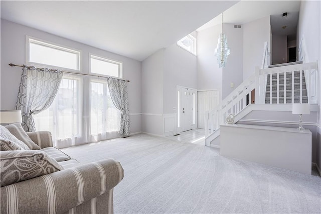 47 Edenfield Rd, Penfield, NY 14526 - living room with stairway, a chandelier, carpet flooring, and a high ceiling