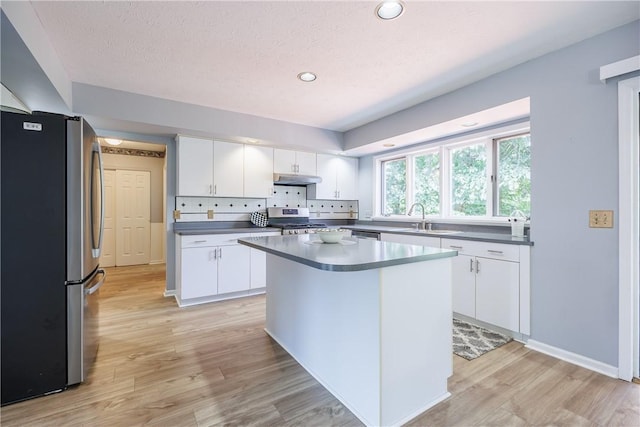 47 Edenfield Rd, Penfield, NY 14526 - kitchen with appliances with stainless steel finishes, under cabinet range hood, dark countertops, white cabinets, and recessed lighting