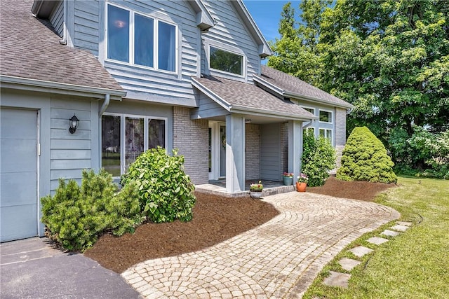 47 Edenfield Rd, Penfield, NY 14526 - entrance to property featuring roof with shingles and brick siding