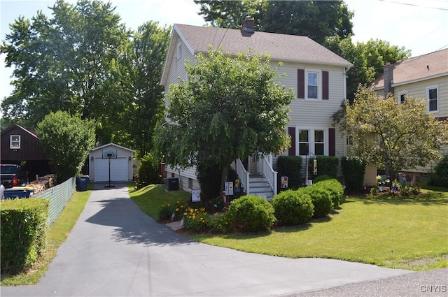 106 Mackay Ave, Camillus, NY 13219 - view of front facade featuring a garage, a front lawn, a chimney, and an outbuilding