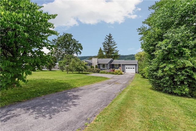 82 Rt 54 E Lake Rd, Milo, NY 14527 - view of front of house featuring an attached garage, asphalt driveway, and a front lawn