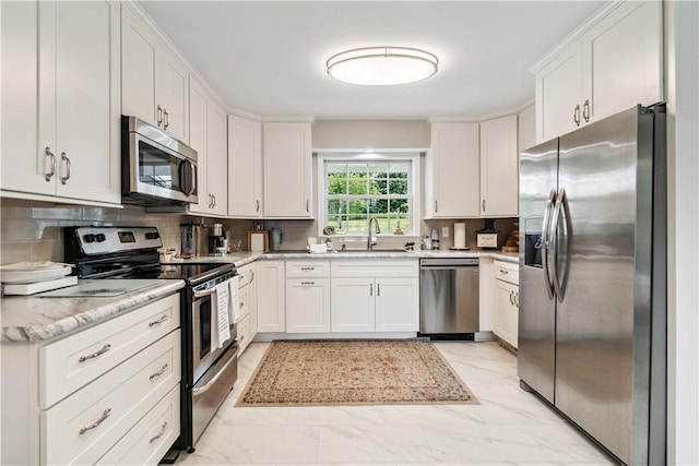 82 Rt 54 E Lake Rd, Milo, NY 14527 - kitchen with appliances with stainless steel finishes, light marble finish floors, white cabinets, and tasteful backsplash