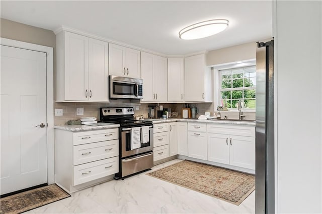 82 Rt 54 E Lake Rd, Milo, NY 14527 - kitchen featuring stainless steel appliances, light marble finish flooring, white cabinetry, and light countertops