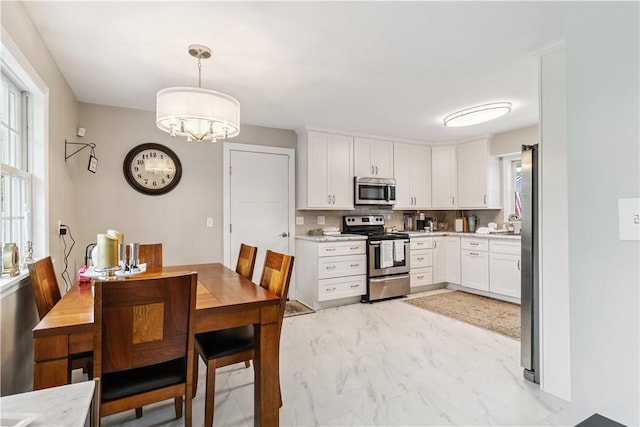 82 Rt 54 E Lake Rd, Milo, NY 14527 - kitchen featuring stainless steel appliances, light marble finish floors, light countertops, and white cabinetry