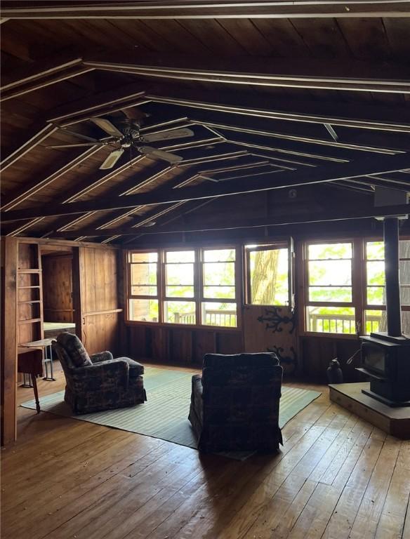 1677 Long Point Beach Rd, Torrey, NY 14527 - living room featuring a wood stove, hardwood / wood-style floors, lofted ceiling, ceiling fan, and wood ceiling