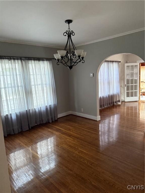 11 Brookline Dr, Utica, NY 13501 - spare room featuring arched walkways, ornamental molding, a chandelier, healthy amount of natural light, and wood finished floors