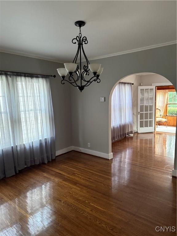 11 Brookline Dr, Utica, NY 13501 - spare room with arched walkways, ornamental molding, wood finished floors, and a chandelier