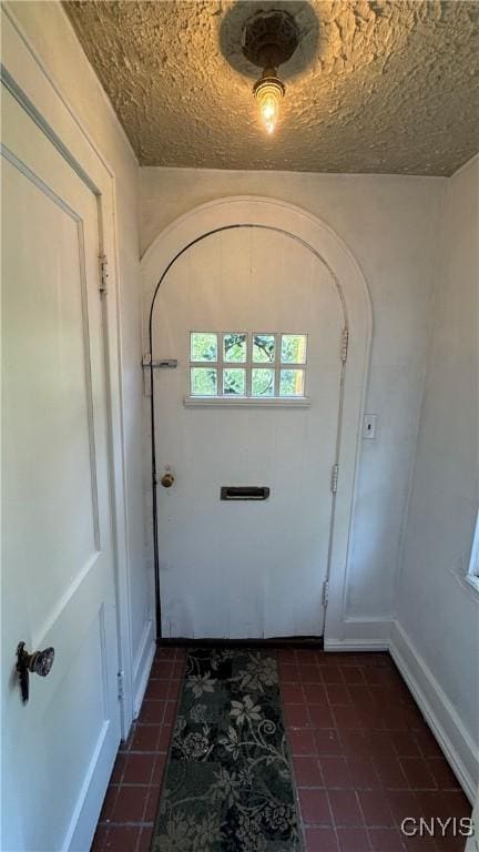 11 Brookline Dr, Utica, NY 13501 - doorway featuring dark tile patterned flooring and arched walkways