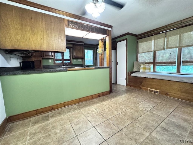 1765 W Rd, Oneida, NY 13421 - kitchen with ceiling fan, dark countertops, light tile patterned floors, ornamental molding, and freestanding refrigerator