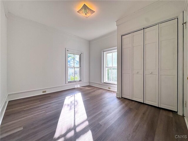 1765 W Rd, Oneida, NY 13421 - unfurnished bedroom with dark wood-style flooring, crown molding, and a closet
