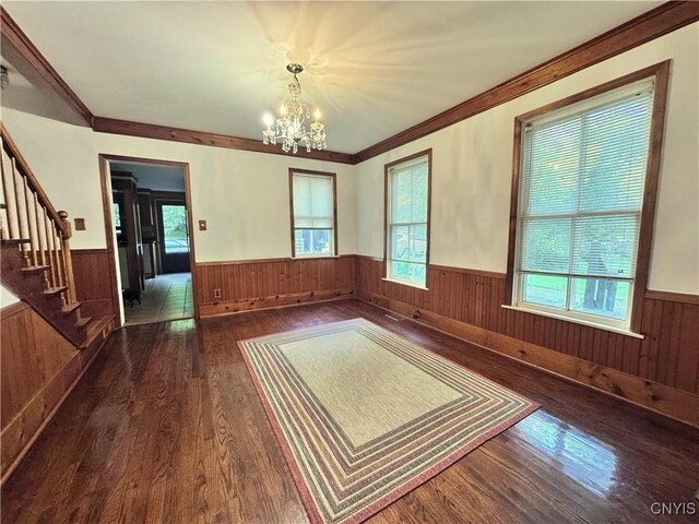 1765 W Rd, Oneida, NY 13421 - unfurnished dining area featuring a wainscoted wall, a chandelier, dark wood-style floors, wooden walls, and stairway