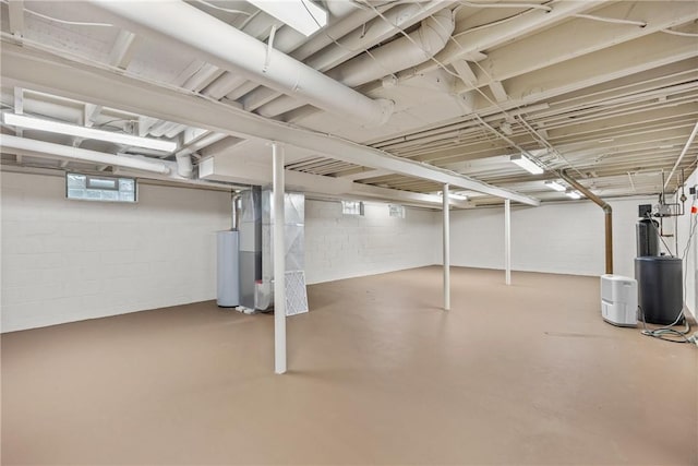 1077 Sharon Ct, Webster, NY 14580 - basement with heating unit, a water softener system, concrete block wall, and gas water heater