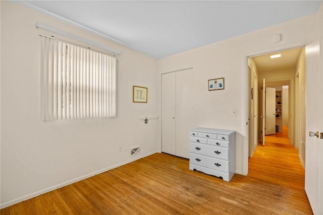 1077 Sharon Ct, Webster, NY 14580 - unfurnished bedroom with light wood-style flooring and a closet