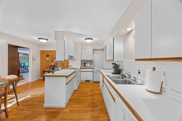 1077 Sharon Ct, Webster, NY 14580 - kitchen with white appliances, white cabinets, a peninsula, decorative backsplash, and light countertops