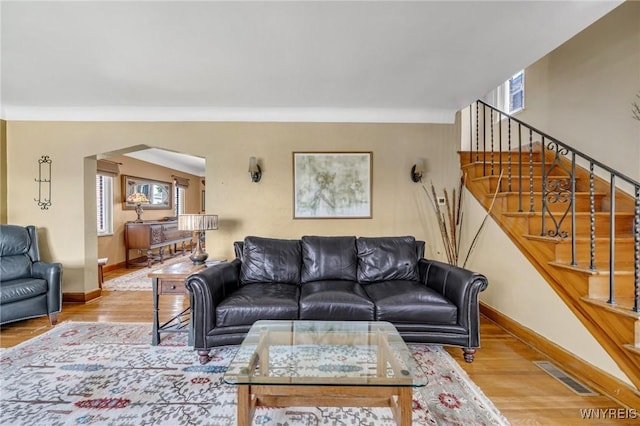 711 Colvin Blvd, Tonawanda, NY 14217 - living area featuring arched walkways, wood finished floors, and stairway