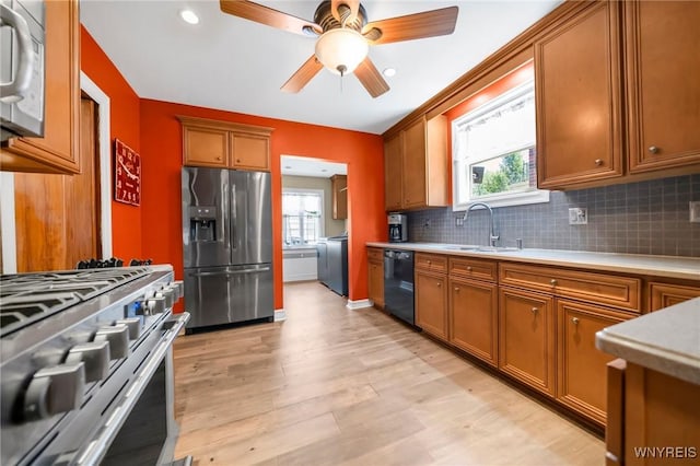 711 Colvin Blvd, Tonawanda, NY 14217 - kitchen featuring stainless steel appliances, light countertops, tasteful backsplash, brown cabinetry, and recessed lighting
