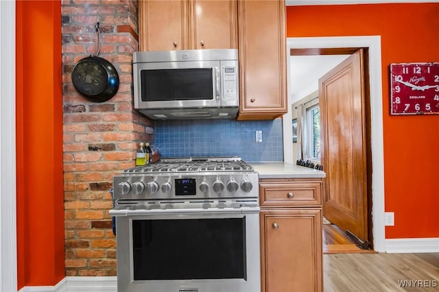 711 Colvin Blvd, Tonawanda, NY 14217 - kitchen featuring stainless steel appliances, light countertops, backsplash, and light wood-style floors