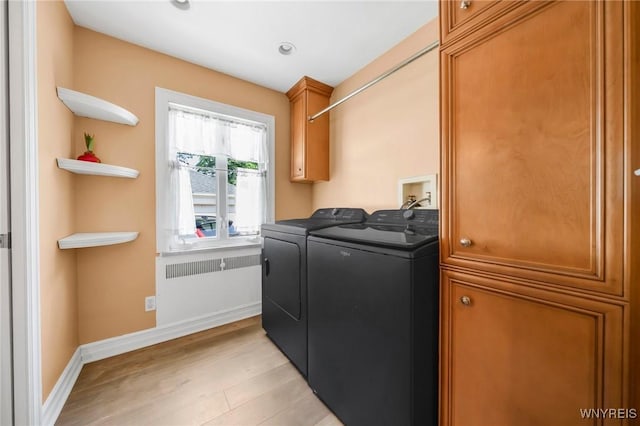 711 Colvin Blvd, Tonawanda, NY 14217 - laundry room with washing machine and clothes dryer, light wood-style floors, and cabinet space