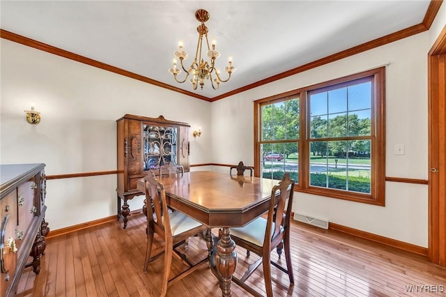 4584 Ridgeview Dr S, Pendleton, NY 14120 - dining room featuring a chandelier, light wood finished floors, and ornamental molding