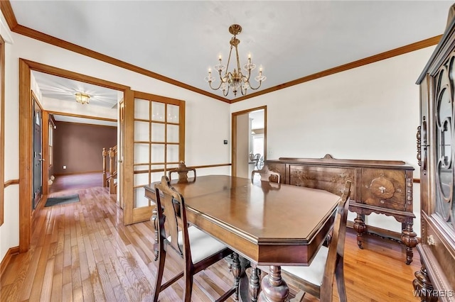 4584 Ridgeview Dr S, Pendleton, NY 14120 - dining room with light wood-type flooring, a chandelier, and ornamental molding