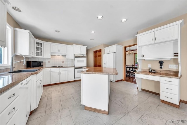4584 Ridgeview Dr S, Pendleton, NY 14120 - kitchen with white appliances, decorative backsplash, white cabinetry, recessed lighting, and glass insert cabinets
