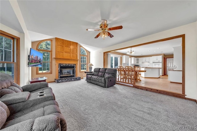 4584 Ridgeview Dr S, Pendleton, NY 14120 - living room featuring ceiling fan, a fireplace, light carpet, lofted ceiling, and a chandelier