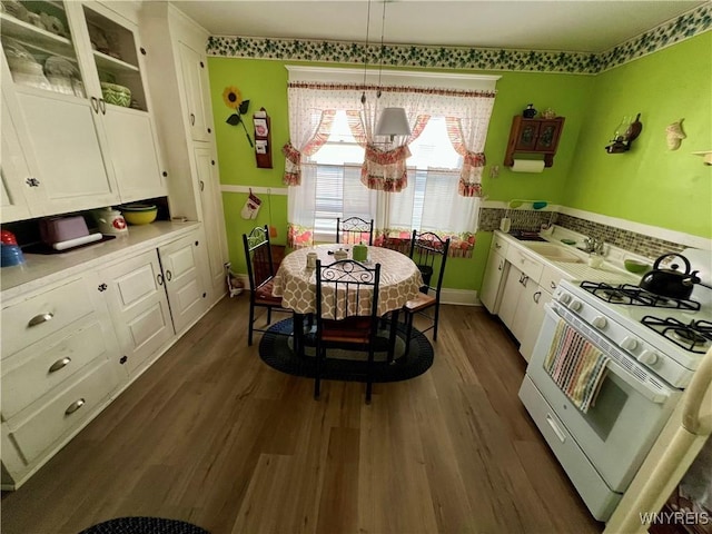 55 Harding Rd, Buffalo, NY 14220 - kitchen with white range with gas cooktop, white cabinets, dark wood-style floors, light countertops, and glass insert cabinets