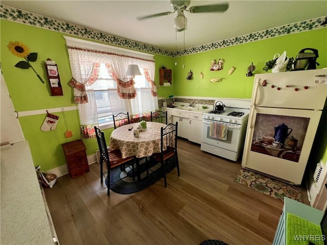 55 Harding Rd, Buffalo, NY 14220 - kitchen featuring white appliances, dark wood-style flooring, white cabinetry, a ceiling fan, and light countertops