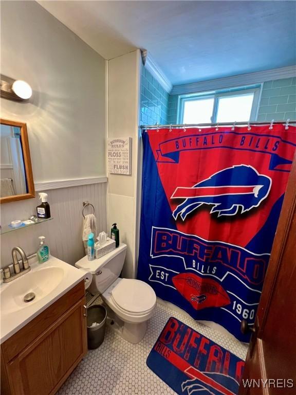 55 Harding Rd, Buffalo, NY 14220 - bathroom featuring vanity, wainscoting, a shower with shower curtain, and tile patterned flooring