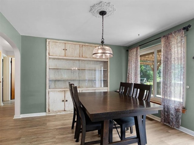 746 Dewitt Rd, Webster, NY 14580 - dining room featuring arched walkways and light wood-style flooring
