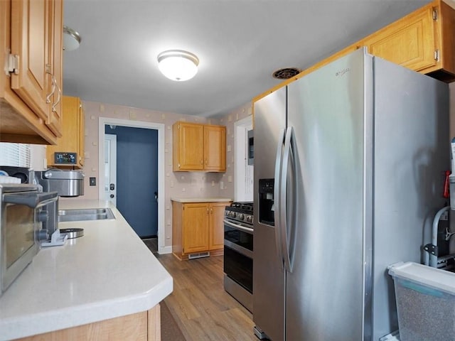 746 Dewitt Rd, Webster, NY 14580 - kitchen with appliances with stainless steel finishes, light countertops, wood finished floors, and light brown cabinetry