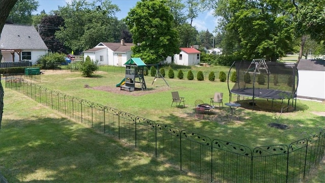 746 Dewitt Rd, Webster, NY 14580 - view of yard featuring a playground, a trampoline, an outdoor fire pit, and an outbuilding