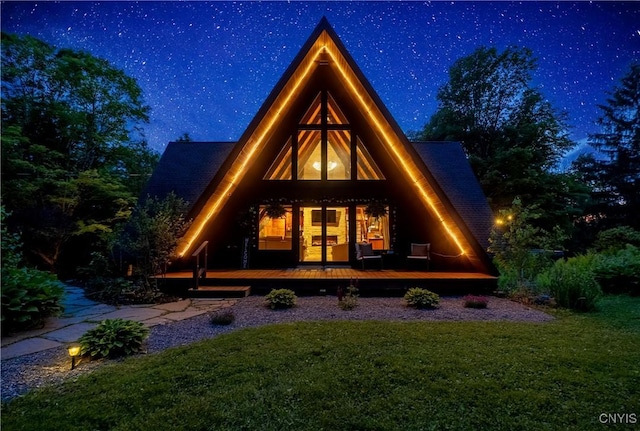 6139 Commane Rd, Lafayette, NY 13084 - back of house at twilight featuring a lawn