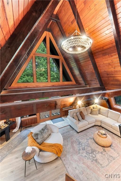 6139 Commane Rd, Lafayette, NY 13084 - living area with wood ceiling, wood finished floors, a chandelier, and wooden walls