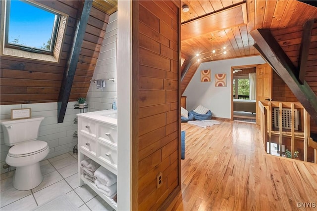 6139 Commane Rd, Lafayette, NY 13084 - bathroom with wooden ceiling, vanity, wood walls, and wood finished floors