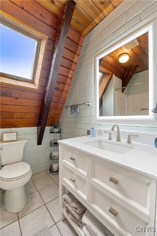 6139 Commane Rd, Lafayette, NY 13084 - bathroom with wooden ceiling, vaulted ceiling, vanity, tile patterned flooring, and wooden walls