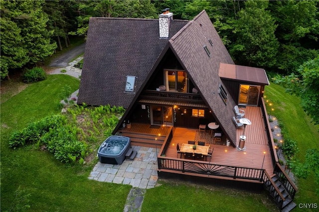 6139 Commane Rd, Lafayette, NY 13084 - rear view of house featuring a deck, roof with shingles, a chimney, a lawn, and outdoor dining space