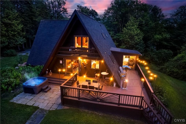 6139 Commane Rd, Lafayette, NY 13084 - back of property with a hot tub, a shingled roof, a patio area, and a wooden deck